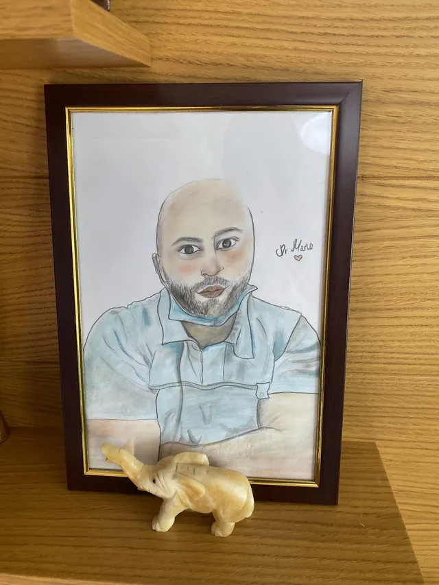 A framed drawing of Dr. Mario in the clinic
